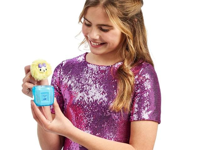 A girl holding a Pikmi Pops Cheeki Puffs plush close to her face